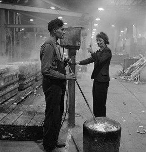 Let's Talk About Class - Mr Hamid, from India, discharged from the British army on medical grounds, inserts a thermocouple into molten metal, waiting for the thumbs-up signal from his colleague, as she lets him know that the correct temperature has been reached. They are working on a Merlin engine at a Rolls Royce aircraft engine factory in 1942 - via Wikimedia Commons