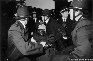 Police constable knocked out during disorder at an anti apartheid rally in Trafalgar Square, London is supported by colleagues as a chief inspector, bleeding from the head looks around for additional assistance.