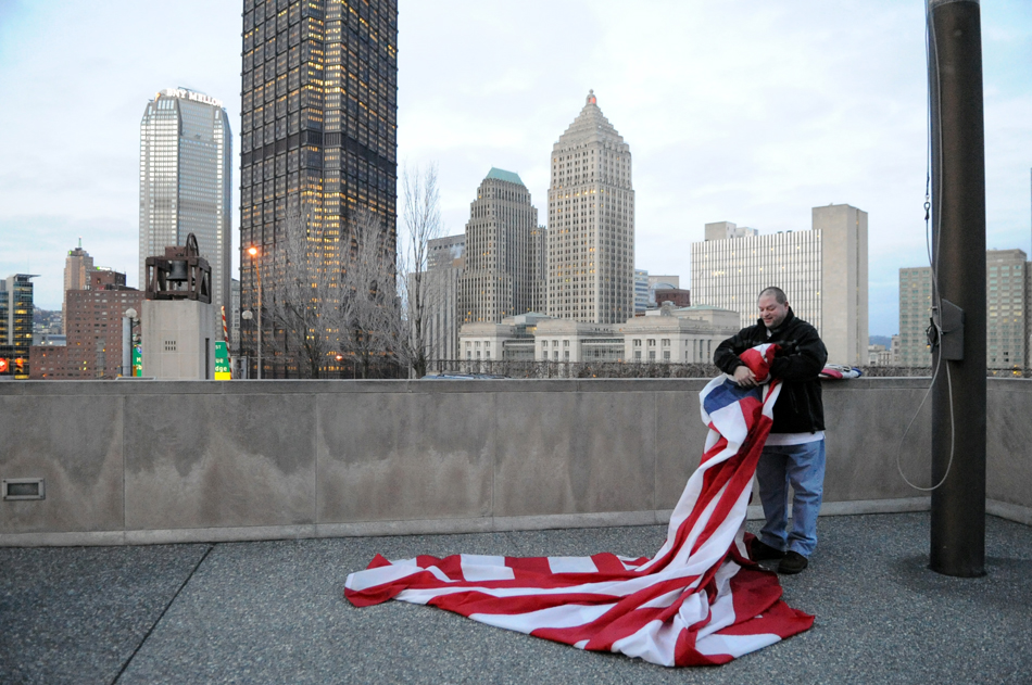 Joel Zwibel, 43, of West View replaces the historic flag with the Bennington Flag at Flag Plaza, Uptown, Monday, February 20, 2012.  There is a different historic flag flown for every day of the month.  (Jasmine Goldband  |  Tribune-Review) (JLG Flag0226.jpg:, goes with Craig Smith story).