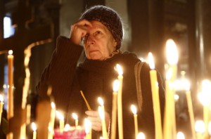A woman prays as she lights a candle in a church in St.Petersburg during a day of national mourning for the plane crash victims in St. Petersburg, Russia, on Sunday, Nov. 1, 2015. A Russian passenger plane has crashed in the Sinai peninsula Saturday with 217 passengers, mostly Russians, and seven Russian crew members killed. (AP Photo/Dmitry Lovetsky) ORG XMIT: XAZ105