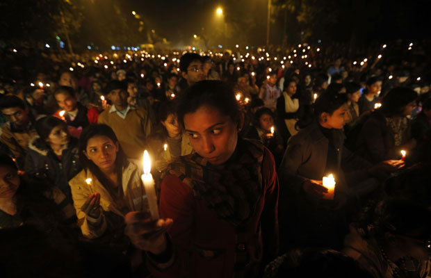 Indians light candles as they mourn the death of a gang rape victim in New Delhi, India , Saturday, Dec. 29, 2012. Indian police charged six men with murder on Saturday, adding to accusations that they beat and gang-raped the woman on a New Delhi bus nearly two weeks ago in a case that shocked the country. The murder charges were laid after the woman died earlier Saturday in a Singapore hospital where she has been flown for treatment. (AP Photo/ Saurabh Das) ORG XMIT: DEL147