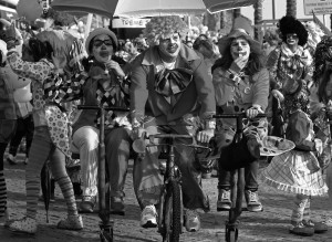 Carnival revellers dressed as clowns pedal on the clowns parade in Sesimbra village February 11, 2013.  REUTERS/Jose Manuel Ribeiro (PORTUGAL - Tags: SOCIETY) - RTR3DNM6